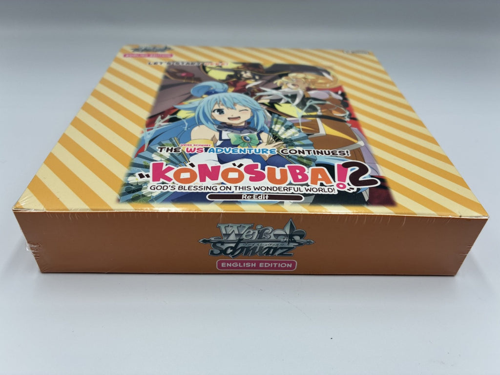 Kong Suba! 2 English Edition box set by Wilt Schwartz, featuring a brown base and a lid with yellow diagonal stripes and anime character artwork.