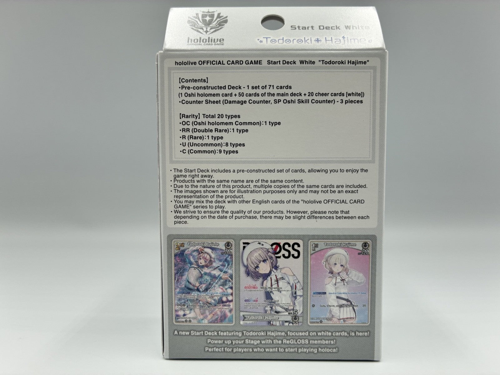 The back of a white and gray box featuring product contents, and character illustrations on the lower section.